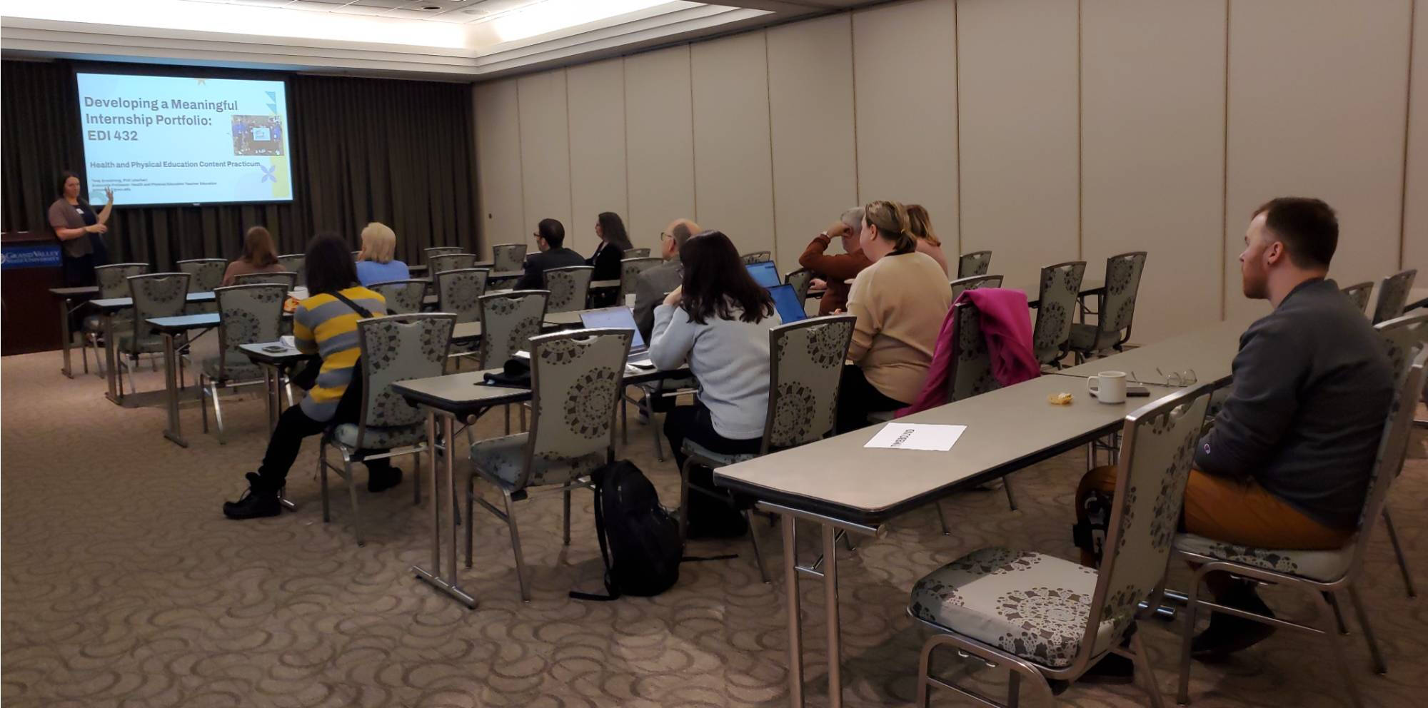 Attendees listen attentively to Tess Armstrong's presentation